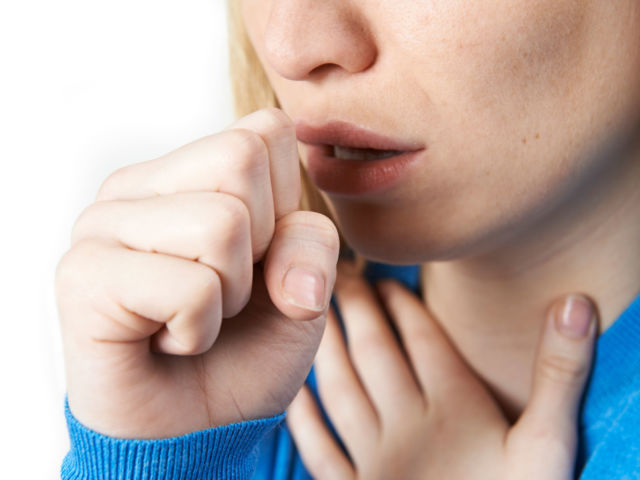 Close Up Of Woman Suffering With Cough