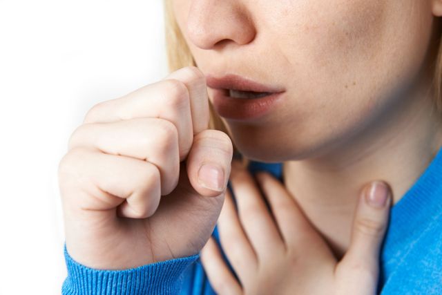 Close Up Of Woman Suffering With Cough